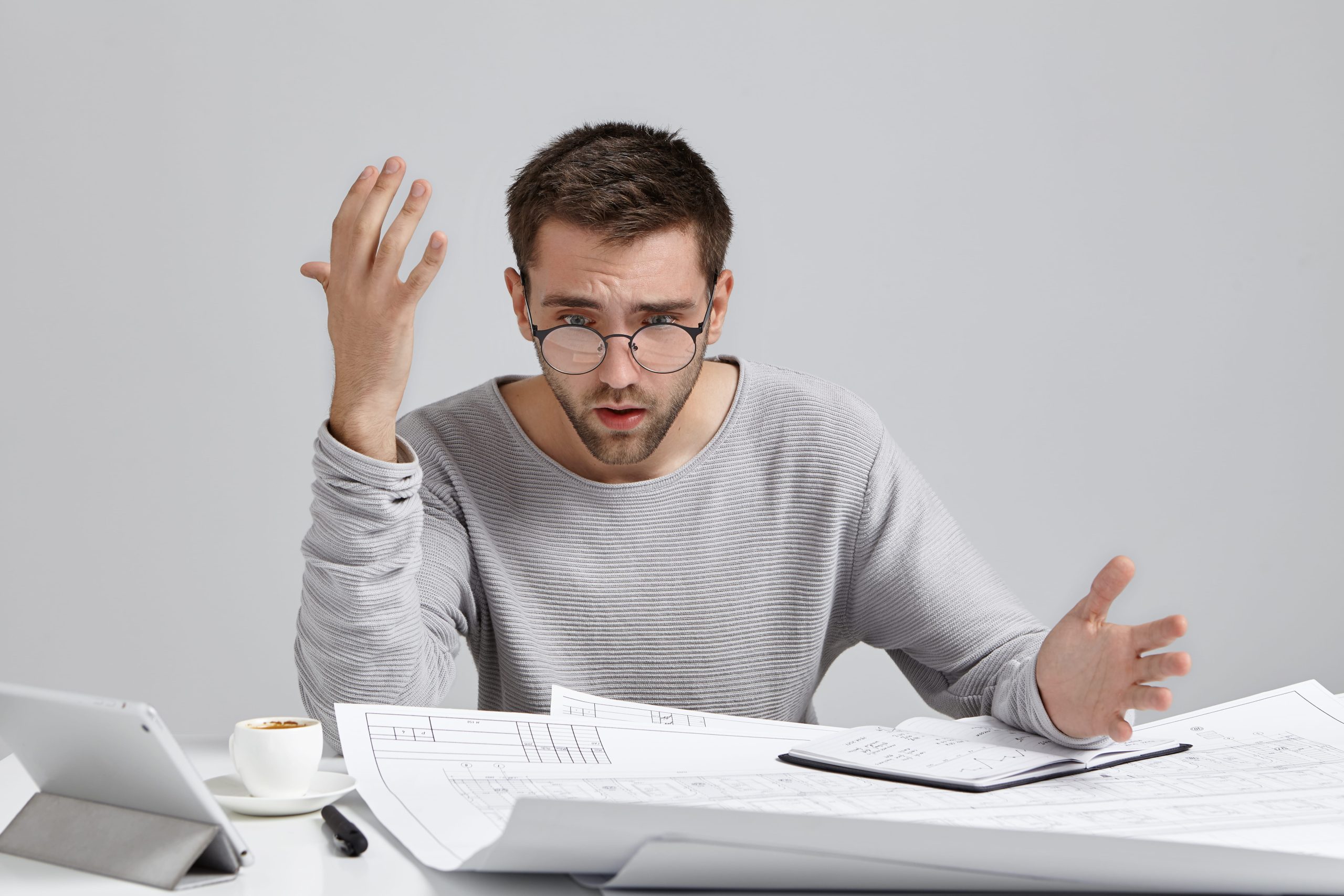 A man at a desk surrounded by paperwork